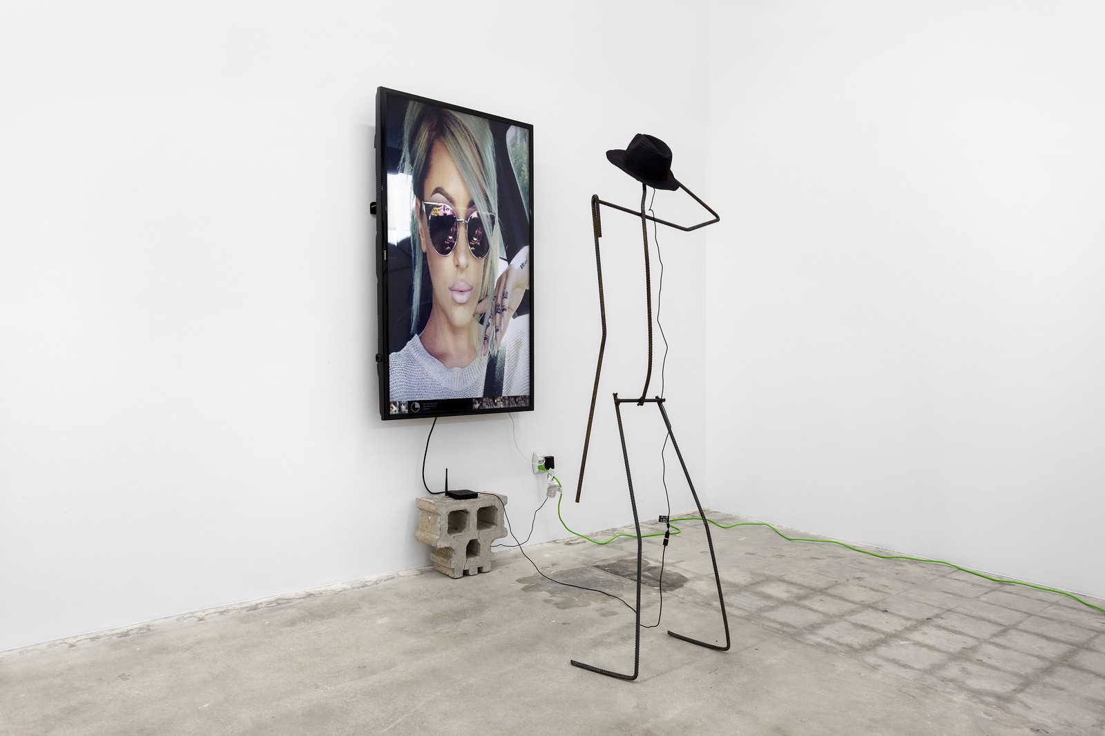 Versteeg_Permanent Vacation_Cement, welded steel, internet-connected computer program with output to 65 inch LCD screen, web cam, straw hat_2016
